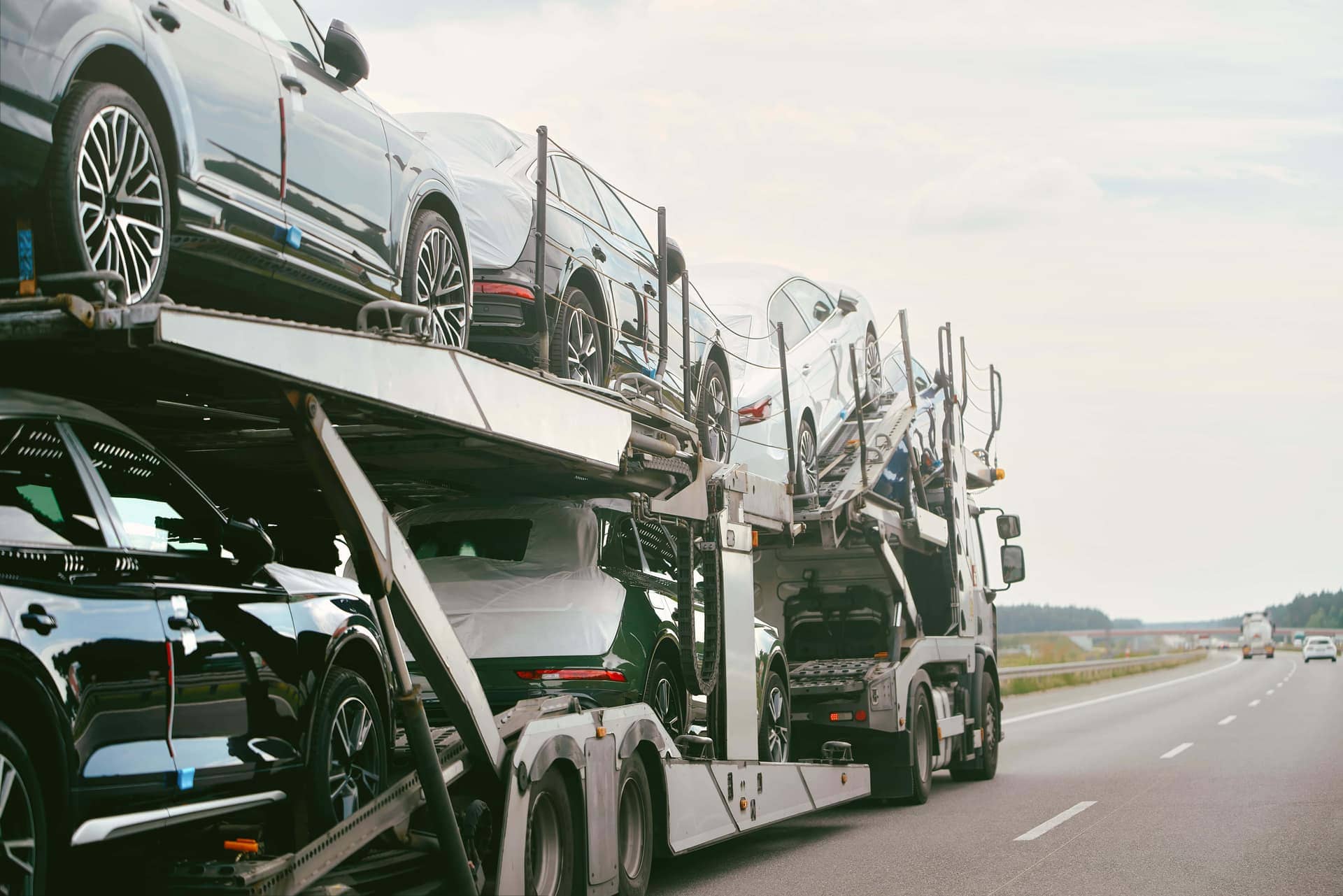 Vehicles loaded on an auto transport carrier on a US highway